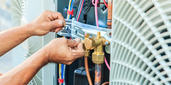 man repairing air conditioner